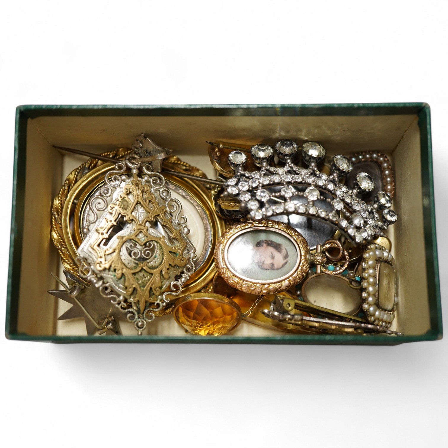 Six assorted 19th century mourning brooches including William IV yellow metal with plaited hair date 1834 and George III with split pearl and hair, largest with carved wax? panel depicting deer, 56mm, together with other